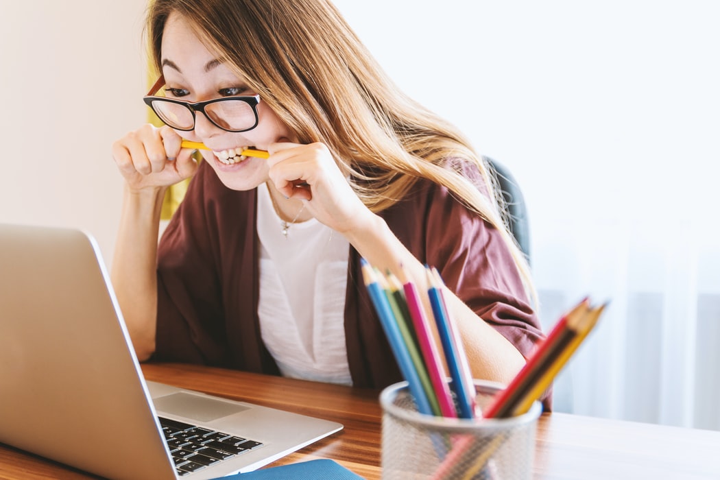 girl biting pencils